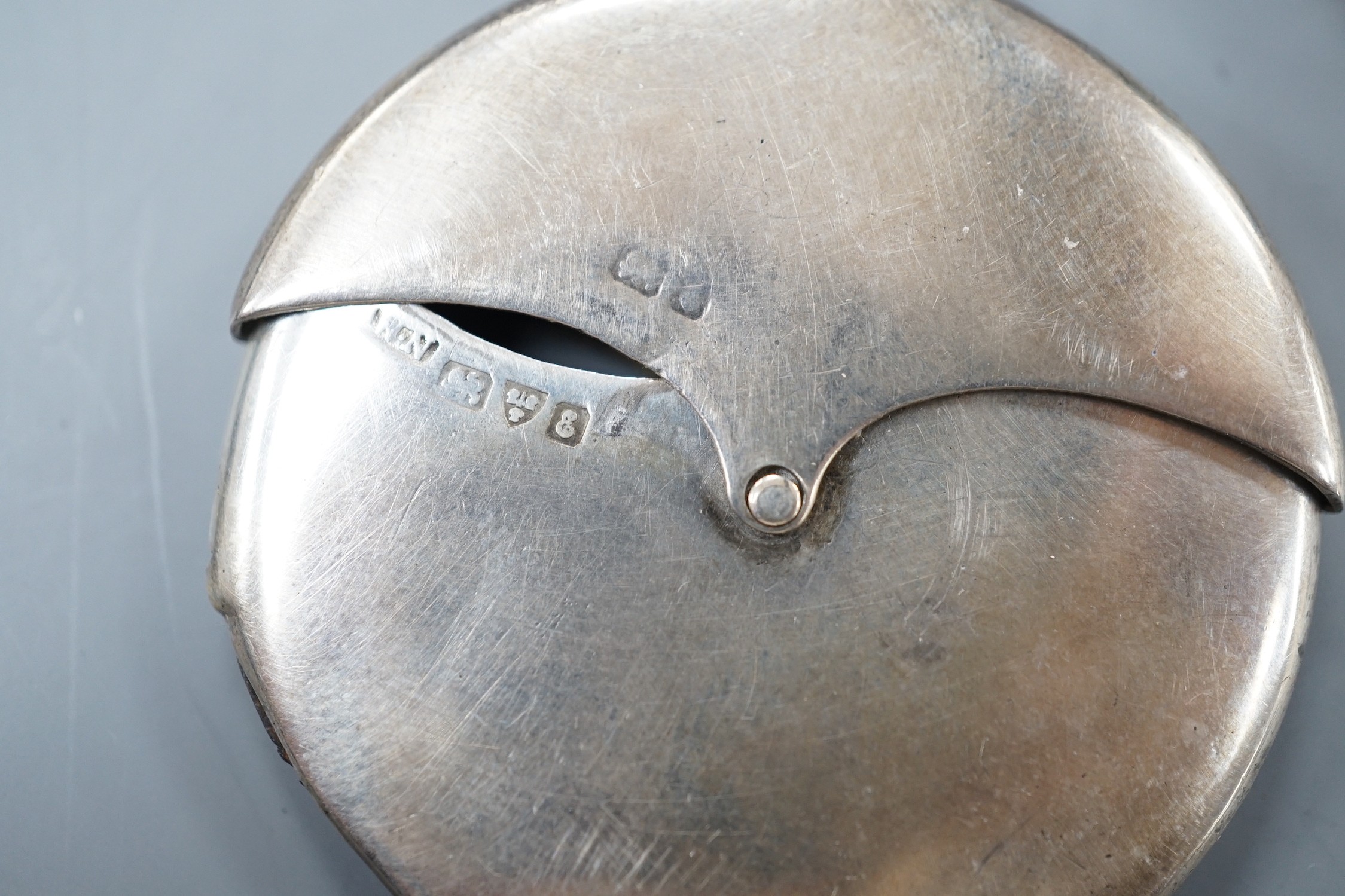 Four assorted early 20th century silver vesta cases, including a silver gilt mounted nut, and patent action circular, together with a sterling vesta case and ornate handled sauce ladle and a mother of pearl handed silver